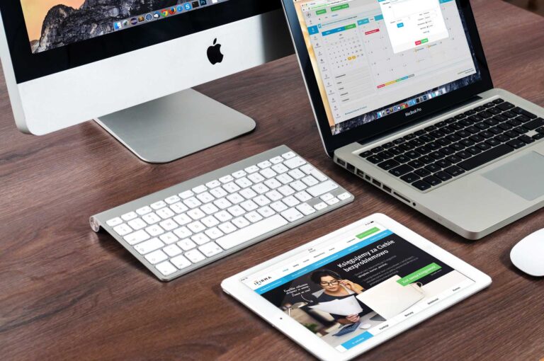 A laptop and a keyboard on a desk, aiding in branding and SEO help for business growth online.